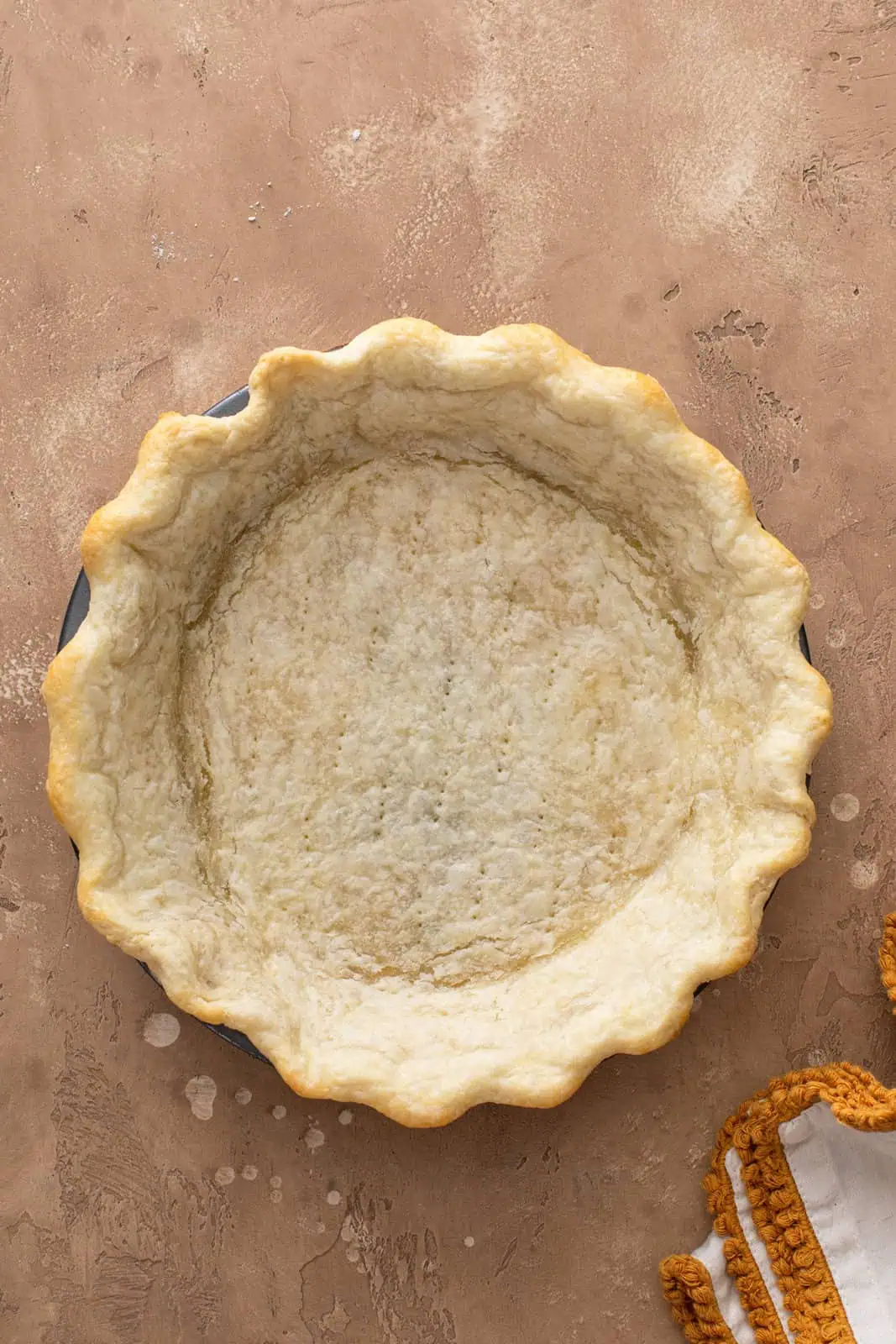 Blind baked pie crust in a pie pan.