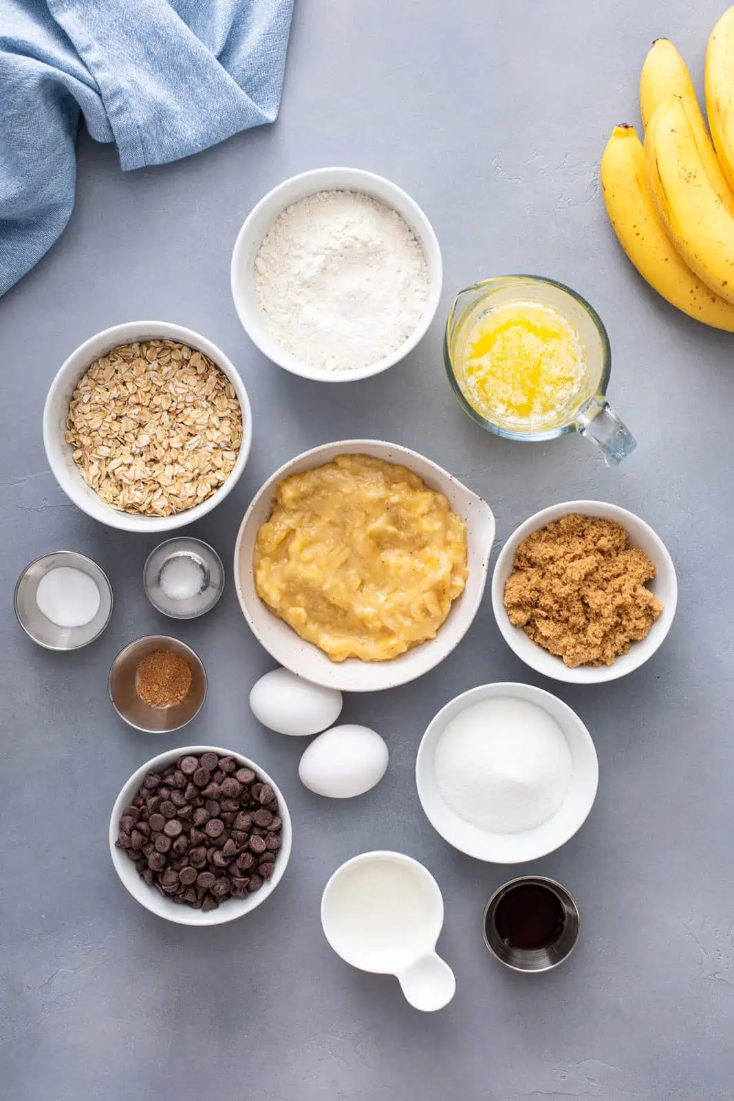 Banana oat muffin ingredients arranged on a gray countertop.