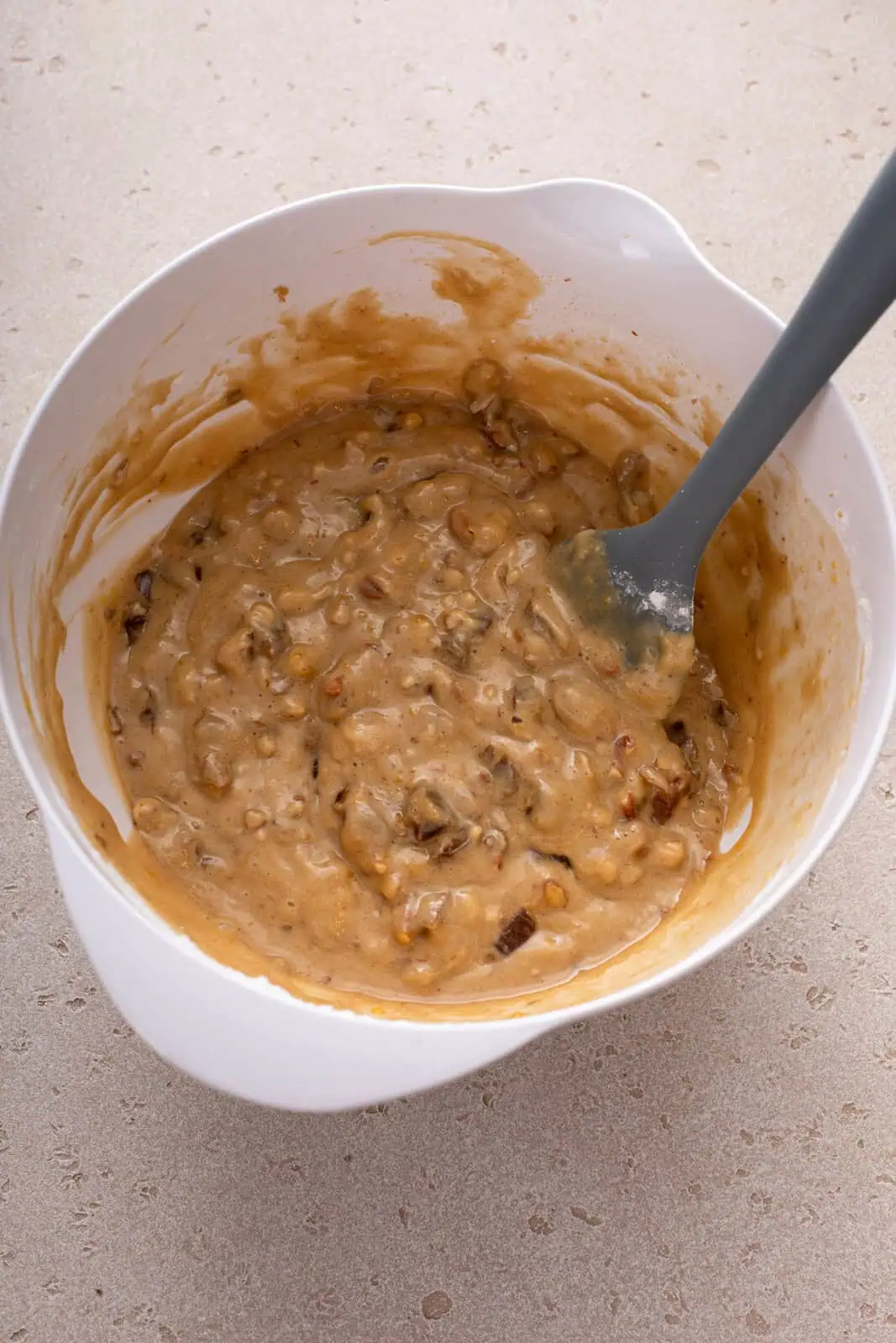 Batter base for date nut bread in a white bowl.