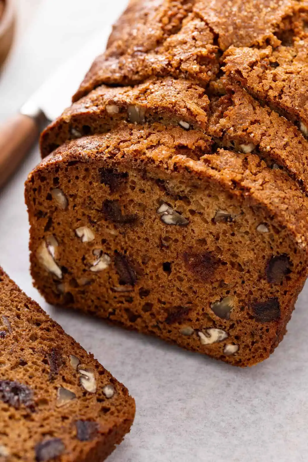 Close up of sliced date nut bread to show the texture of the bread.