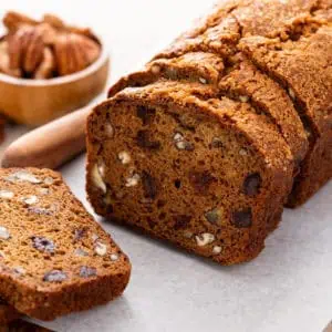 Sliced loaf of date nut bread.