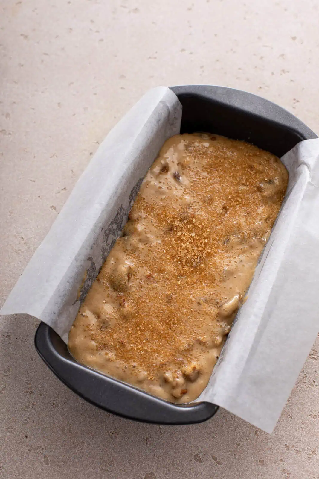 Unbaked date nut bread in a loaf pan, ready to go in the oven.