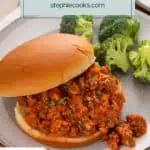 Close up image of a sloppy joe sandwich on a bun set on a plate next to broccoli. Text overlay includes recipe name.