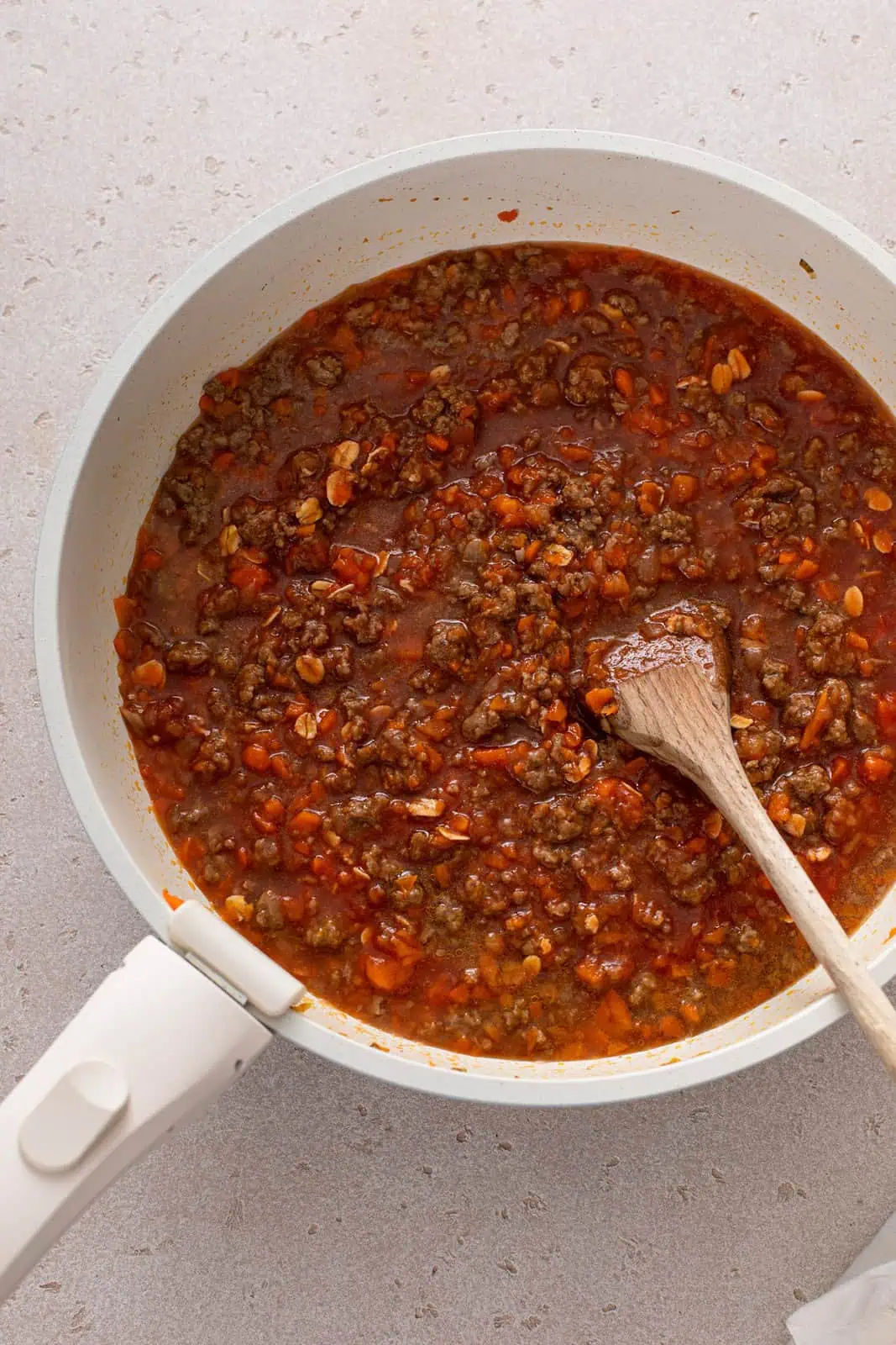 Sloppy joe meat mixture simmering in a skillet.