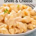Close up of a bowl filled with homemade shells and cheese. Text overlay includes recipe name.
