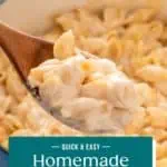 Wooden spoon holding up homemade shells and cheese over a pot of the pasta. Text overlay includes recipe name.