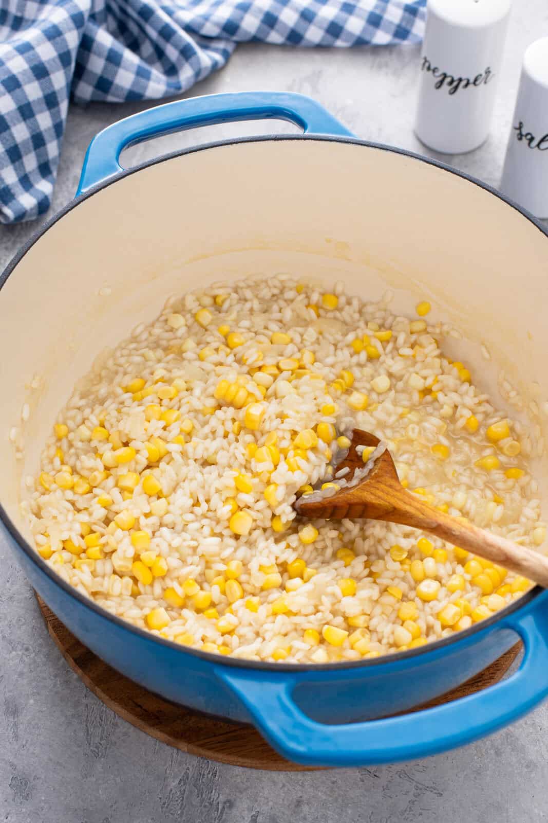 Sweet corn being added to partially cooked risotto.