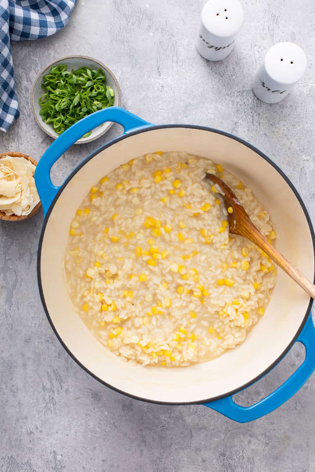 Overhead view of cooked sweet corn risotto in a dutch oven.