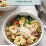 White bowl filled with easy tortellini soup topped with parmesan cheese. Text overlay includes recipe name.