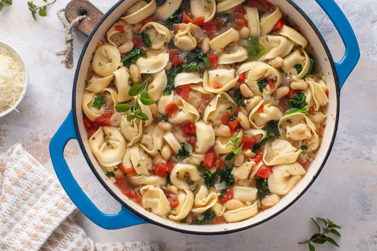 Overhead view of easy tortellini soup in a dutch oven.