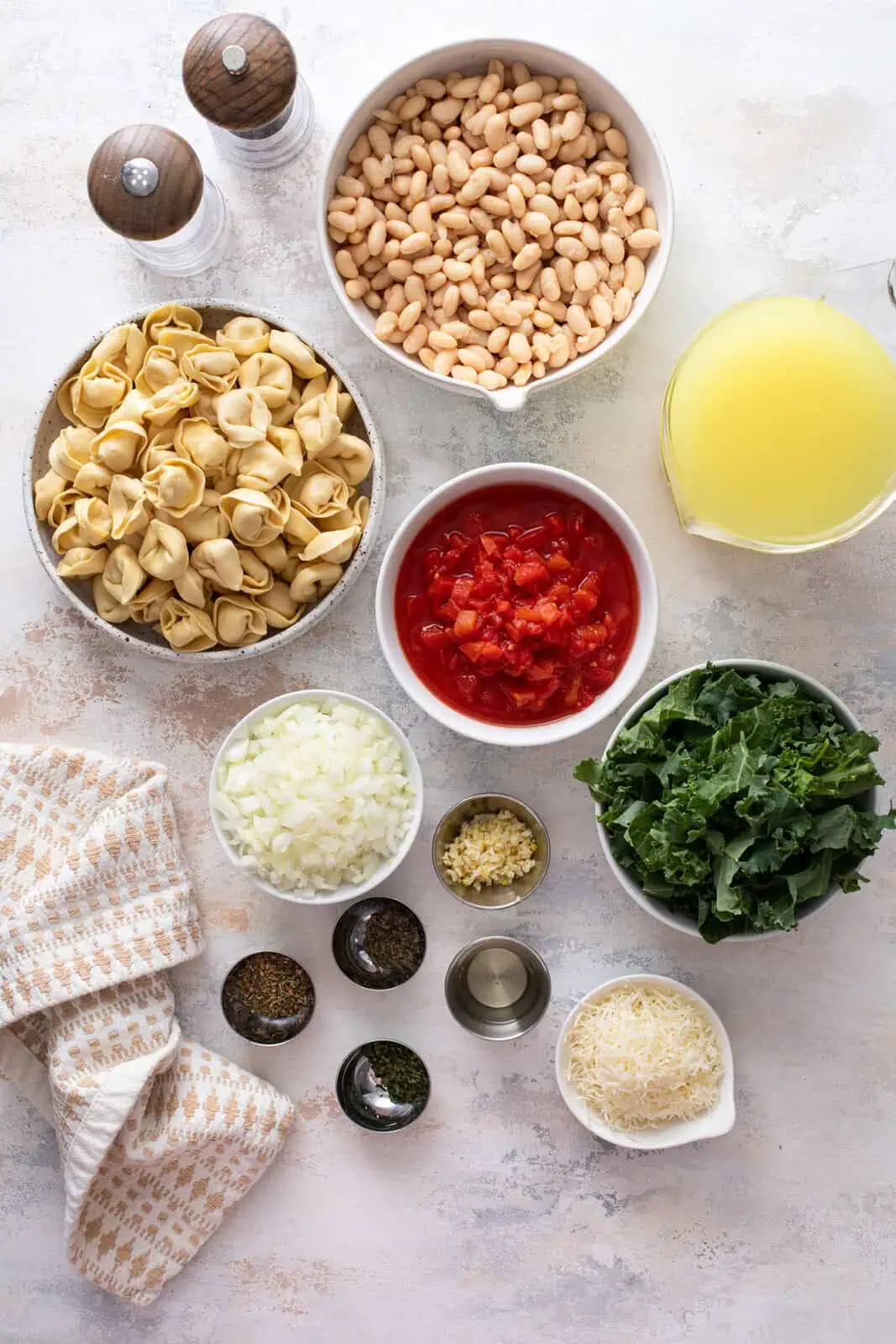 Ingredients for easy tortellini soup arranged on a countertop.