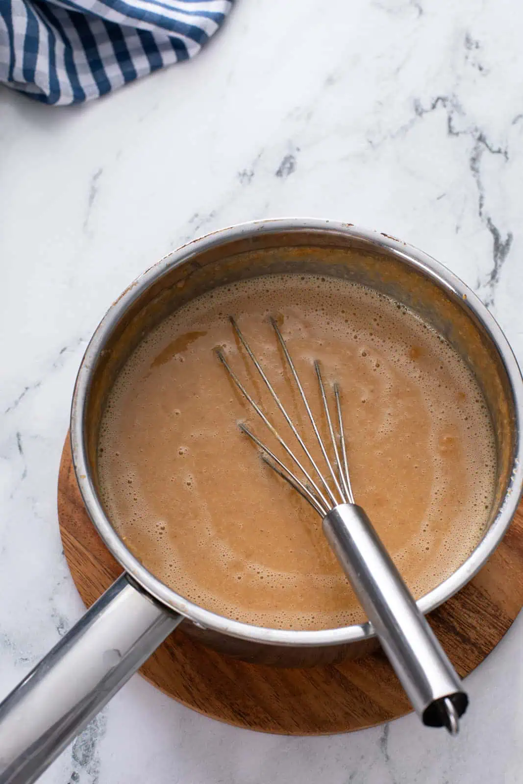 Cooked sweet potato pie filling in a saucepan.