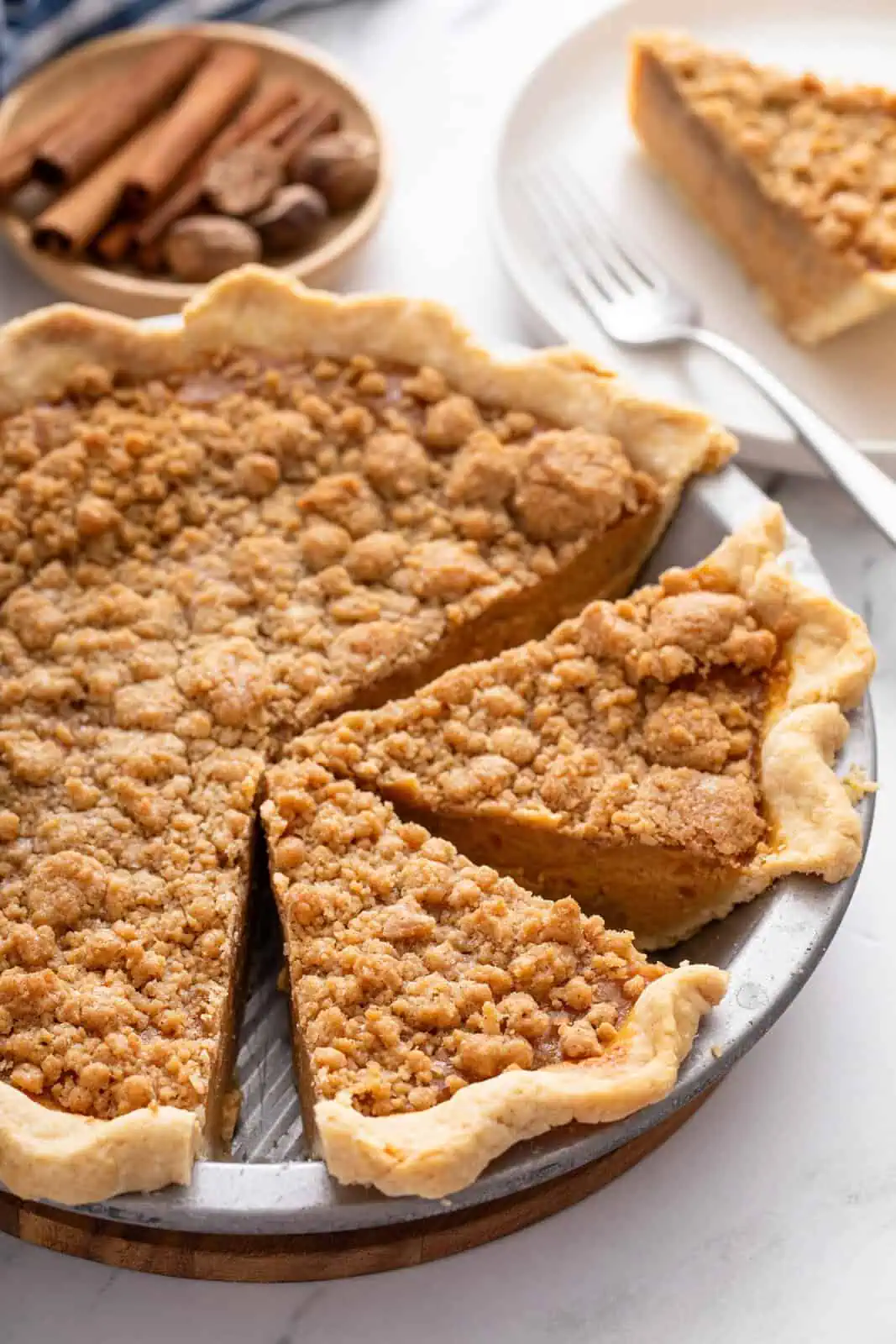 Sliced sweet potato pie in a deep-dish pie plate.