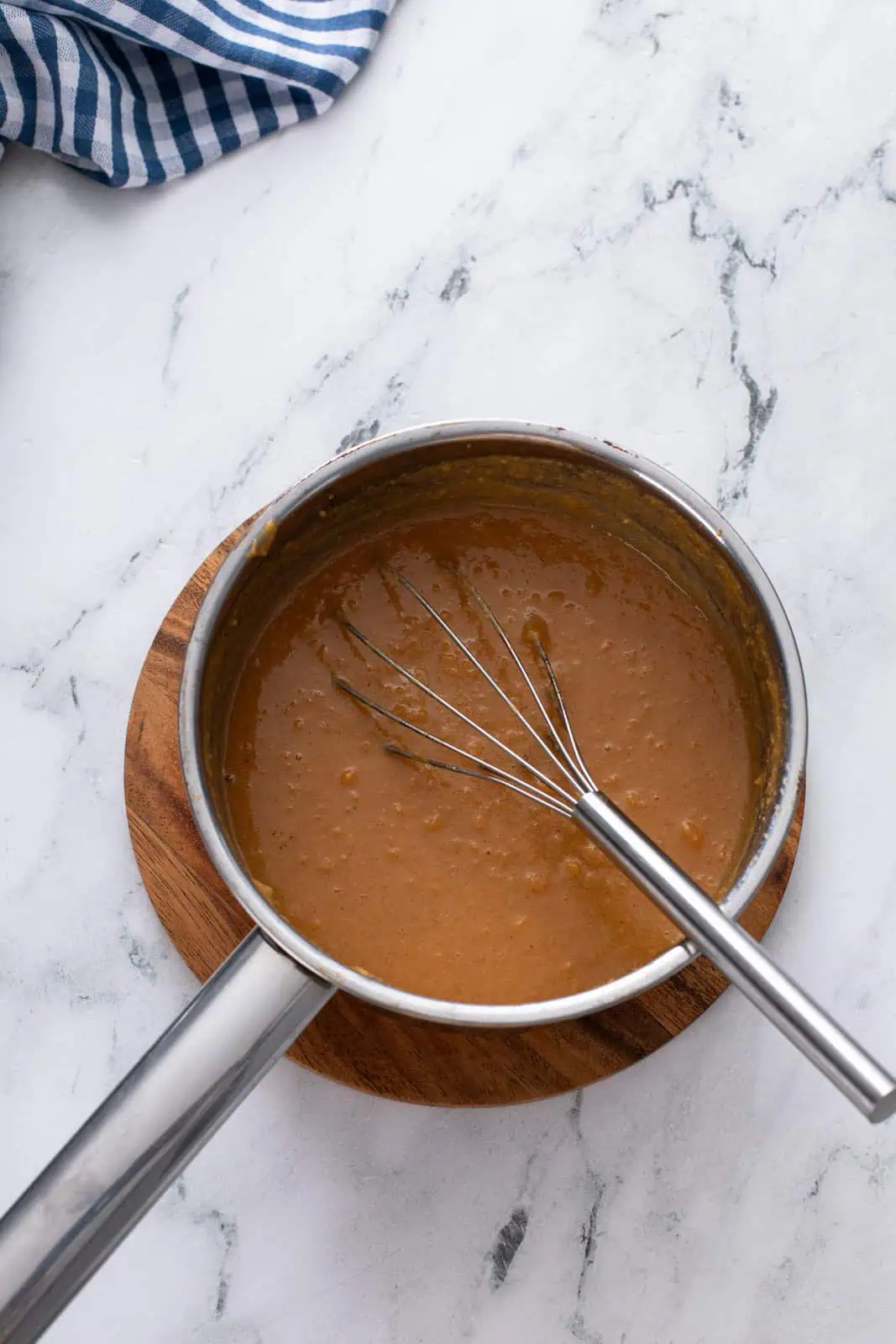 Sweet potato and sugar cooked in a saucepan.