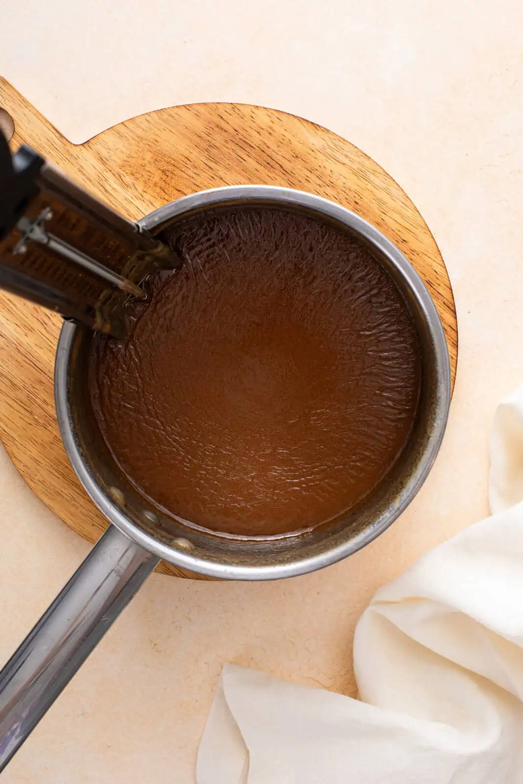 Mixture for brown sugar fudge cooling in a saucepan.