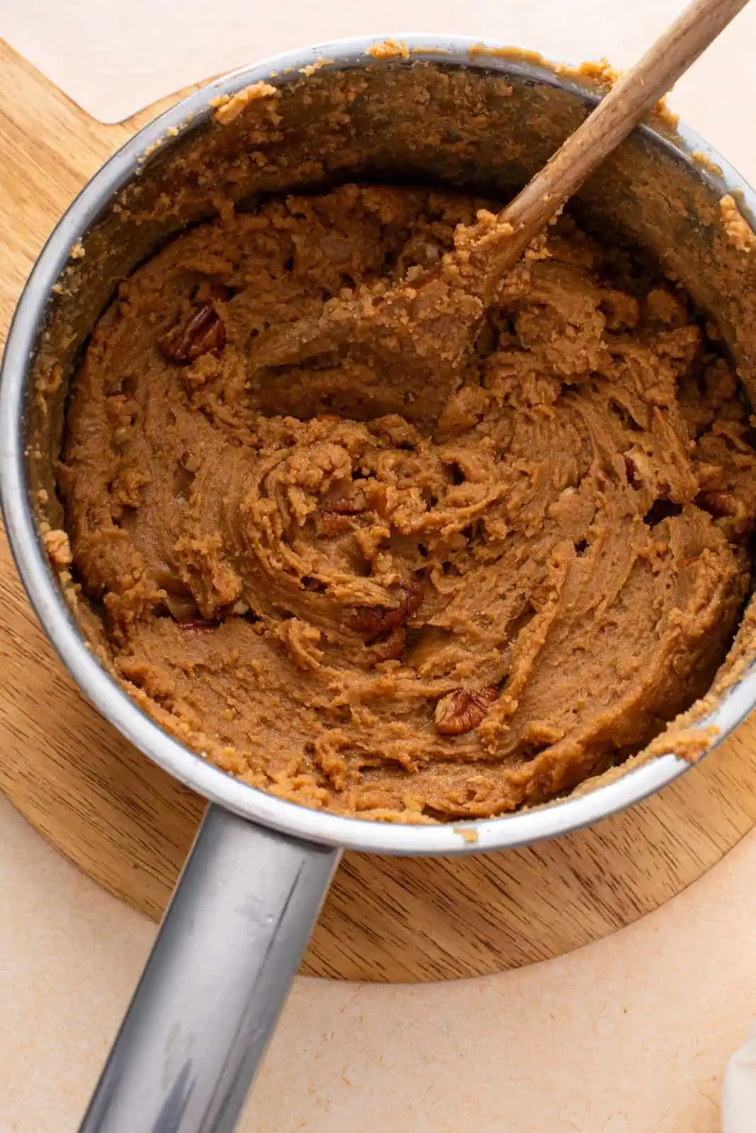 Brown sugar fudge stirred in a saucepan and ready to be spread into a baking dish.