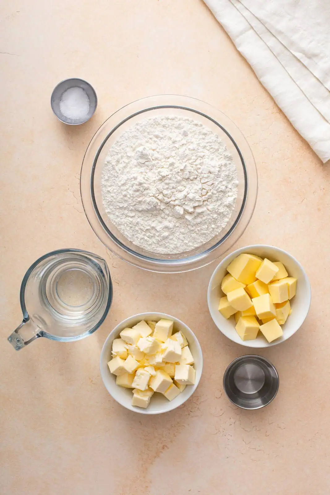 Homemade pie crust ingredients arranged on a countertop.