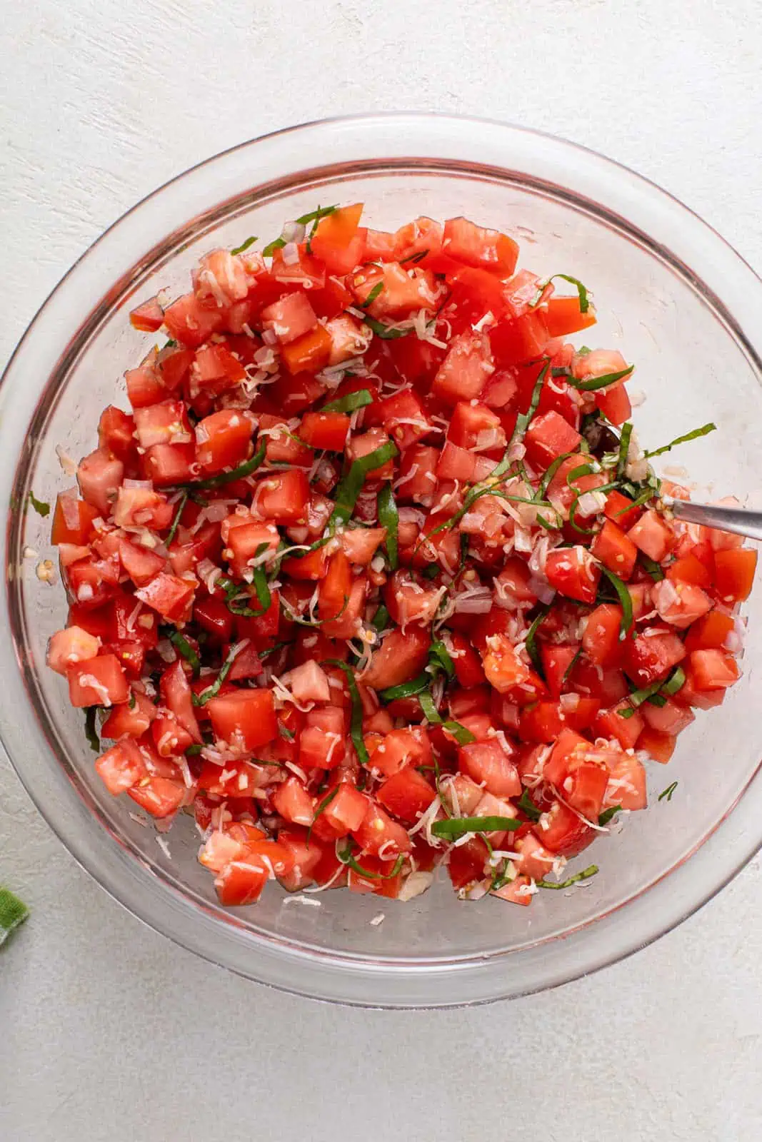 Tomato bruschetta topping mixed in a glass bowl.