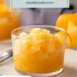 Glass of bourbon slush garnished with an orange twist. Text overlay includes recipe name
