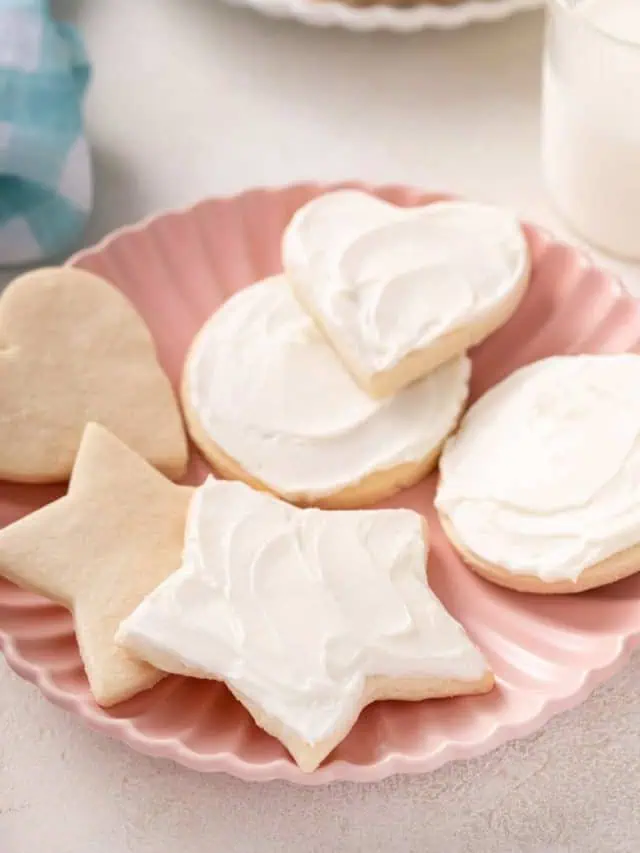 No chill sugar cookies in star, heart, and circle shapes on a pink plate.