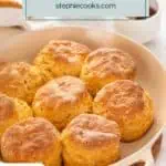 Eight baked sweet potato biscuits arranged in a skillet. Text overlay includes recipe name.