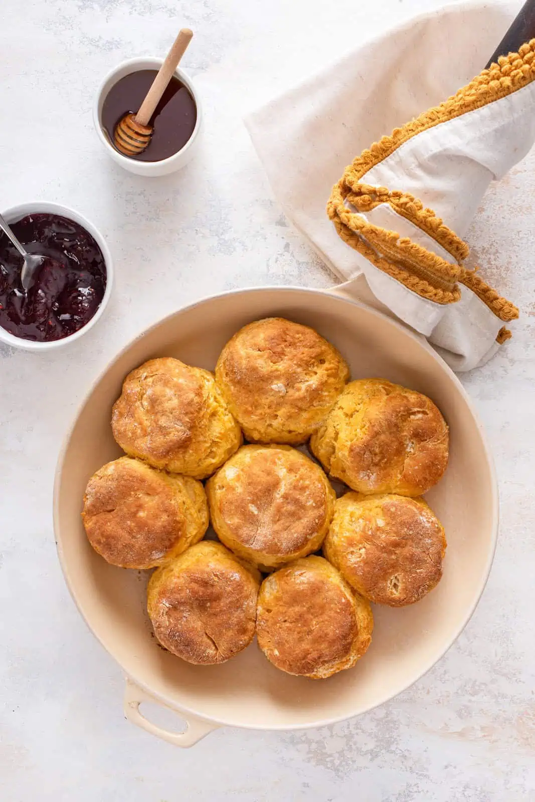 Overhead view of baked sweet potato biscuits in a skillet.