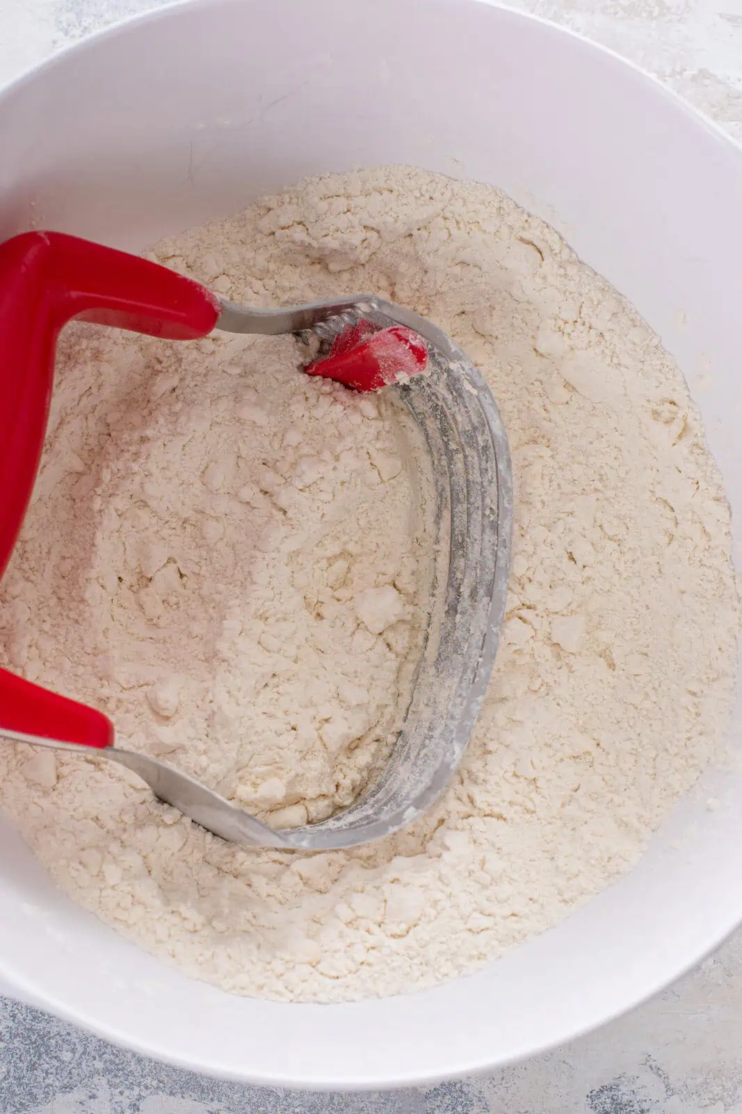 Butter cut into dry ingredients for biscuits with a pastry blender.