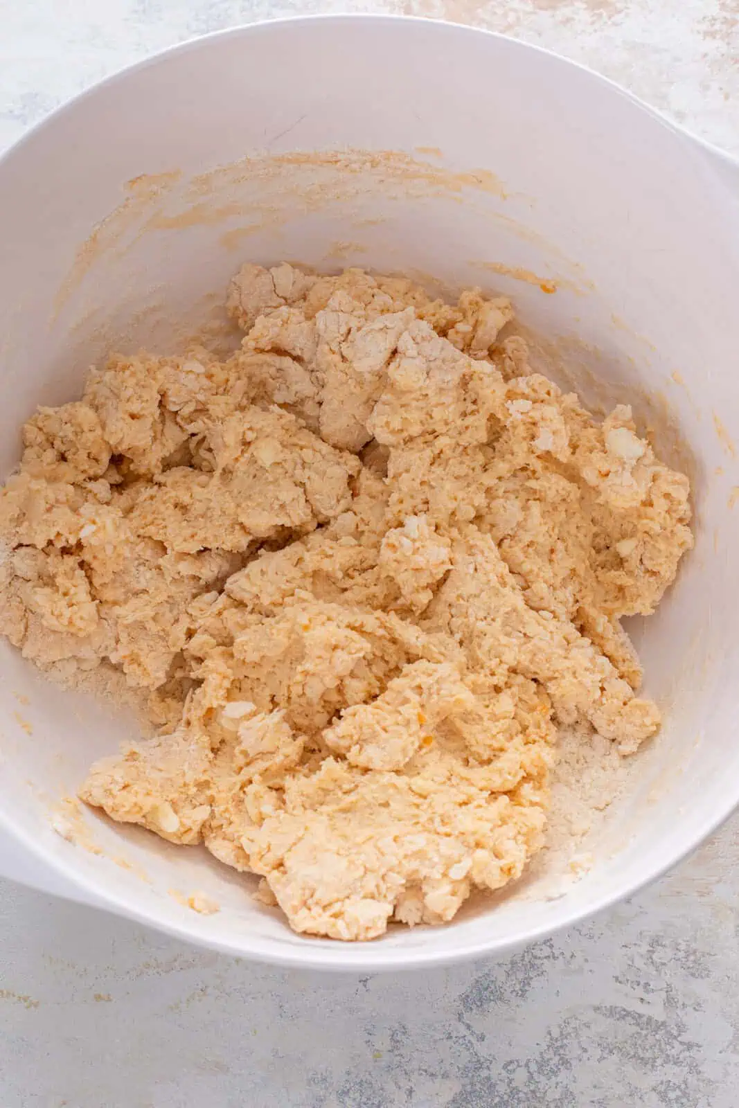 Sweet potato biscuit dough in a white bowl.