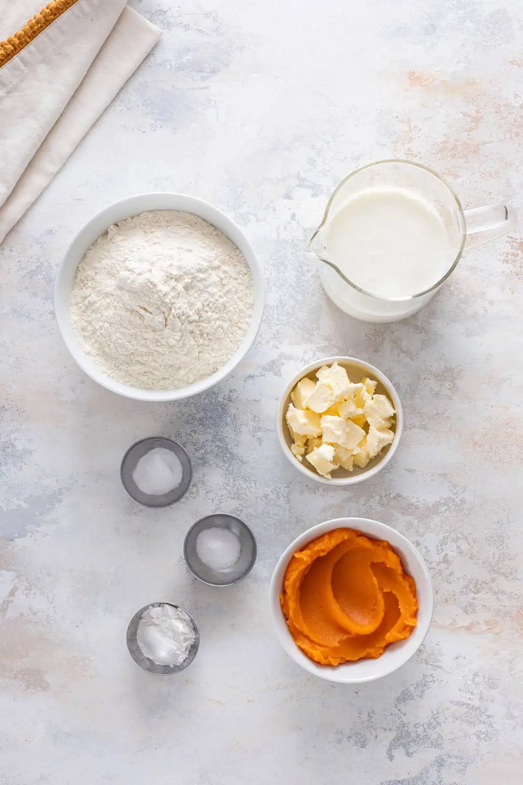 Sweet potato biscuit ingredients arranged on a countertop.