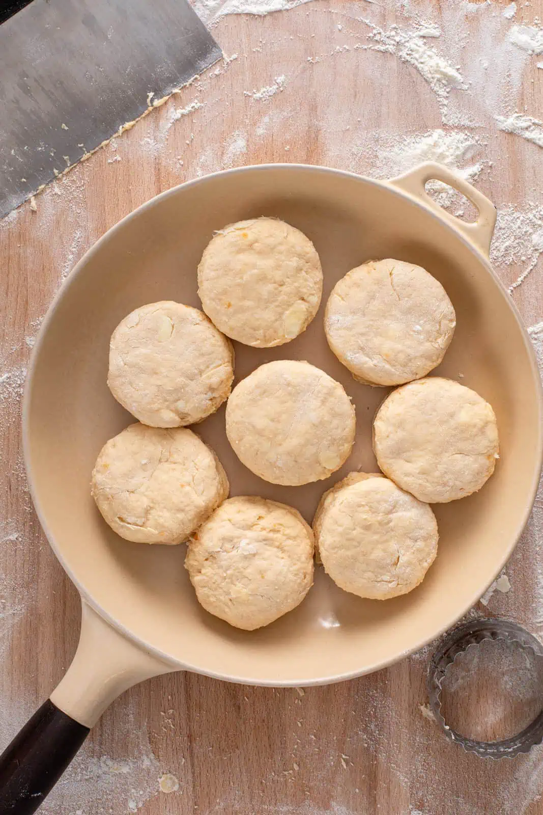 Cut, unbaked sweet potato biscuits arranged in a skillet.