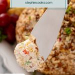 Bite of pineapple cheese ball on a cheese knife. Text overlay includes recipe name.