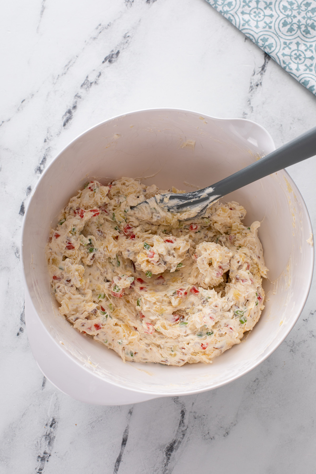 Base for pineapple pecan cheese ball mixed in a white bowl.