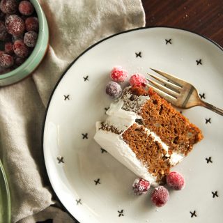 Gingerbread Layer Cake is garnished with sugared cranberries for a perfectly festive dessert