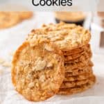 Several almond lace cookies stacked on a piece of parchment with one cookie leaning against the stack. Text overlay includes recipe name.