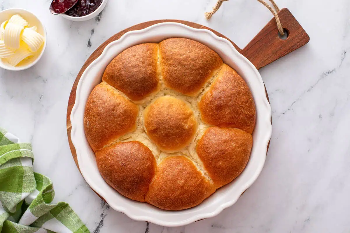 Overhead view of a pan of baked refrigerator rolls.