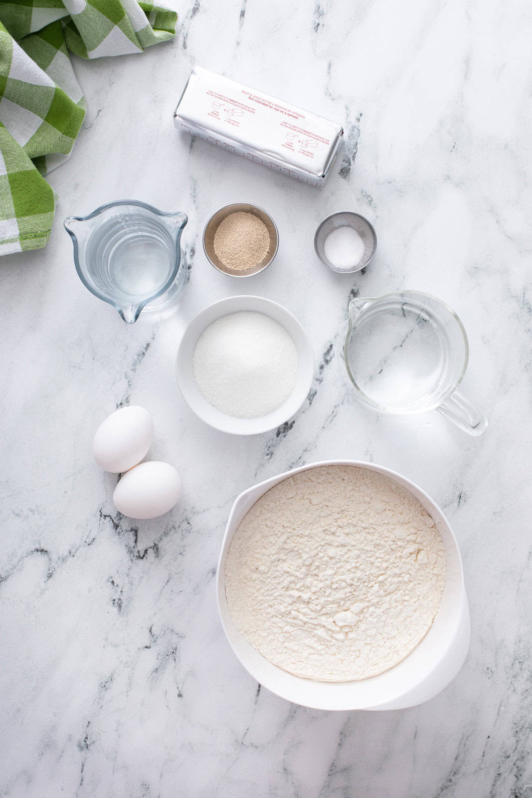 Ingredients for no-knead refrigerator rolls on a marble countertop.