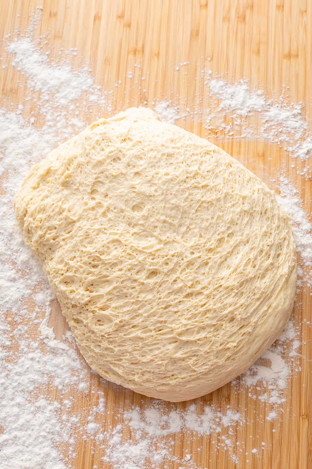 Risen yeast dough turned out onto a floured board.