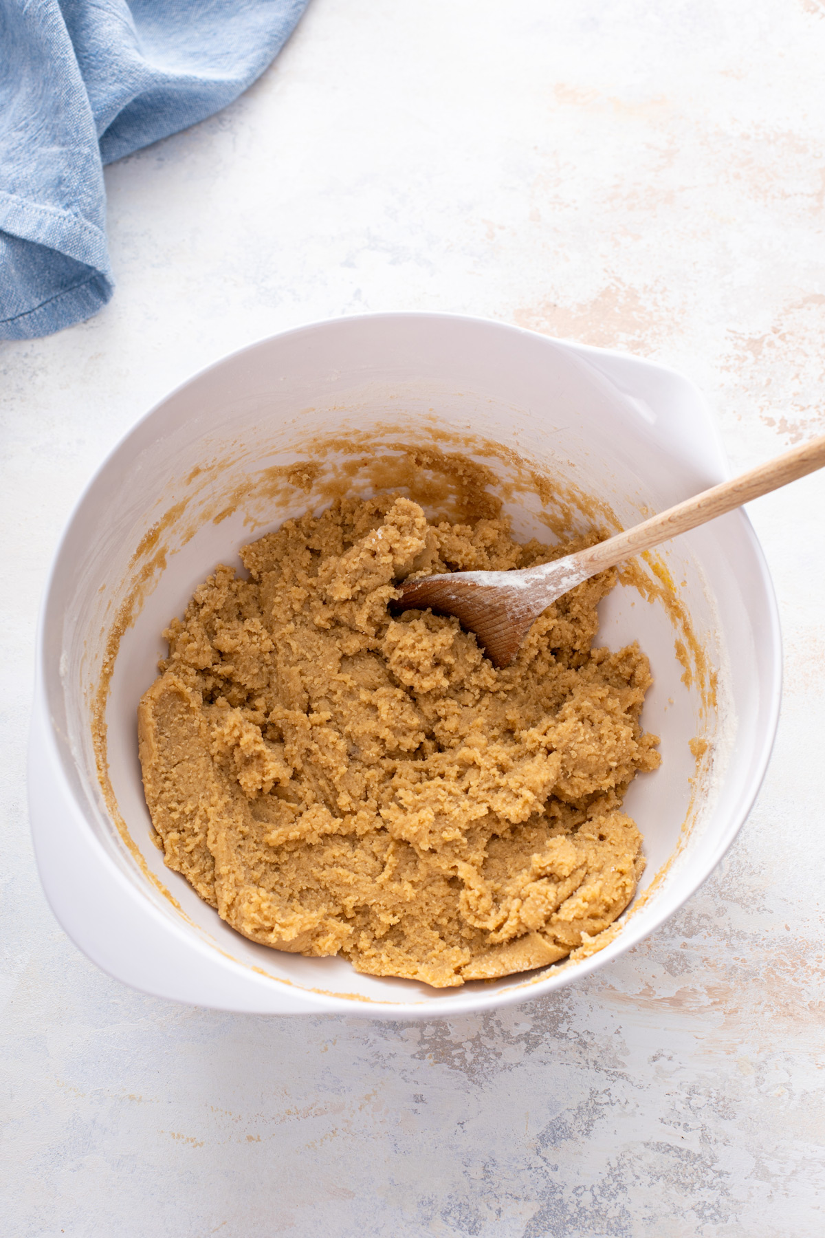 Dough for chocolate chipless cookies mixed in a white bowl.