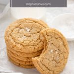 Stack of chocolate chipless cookies next to a glass of milk with a cookie with a bite taken from it leaning against the stack. Text overlay includes recipe name.