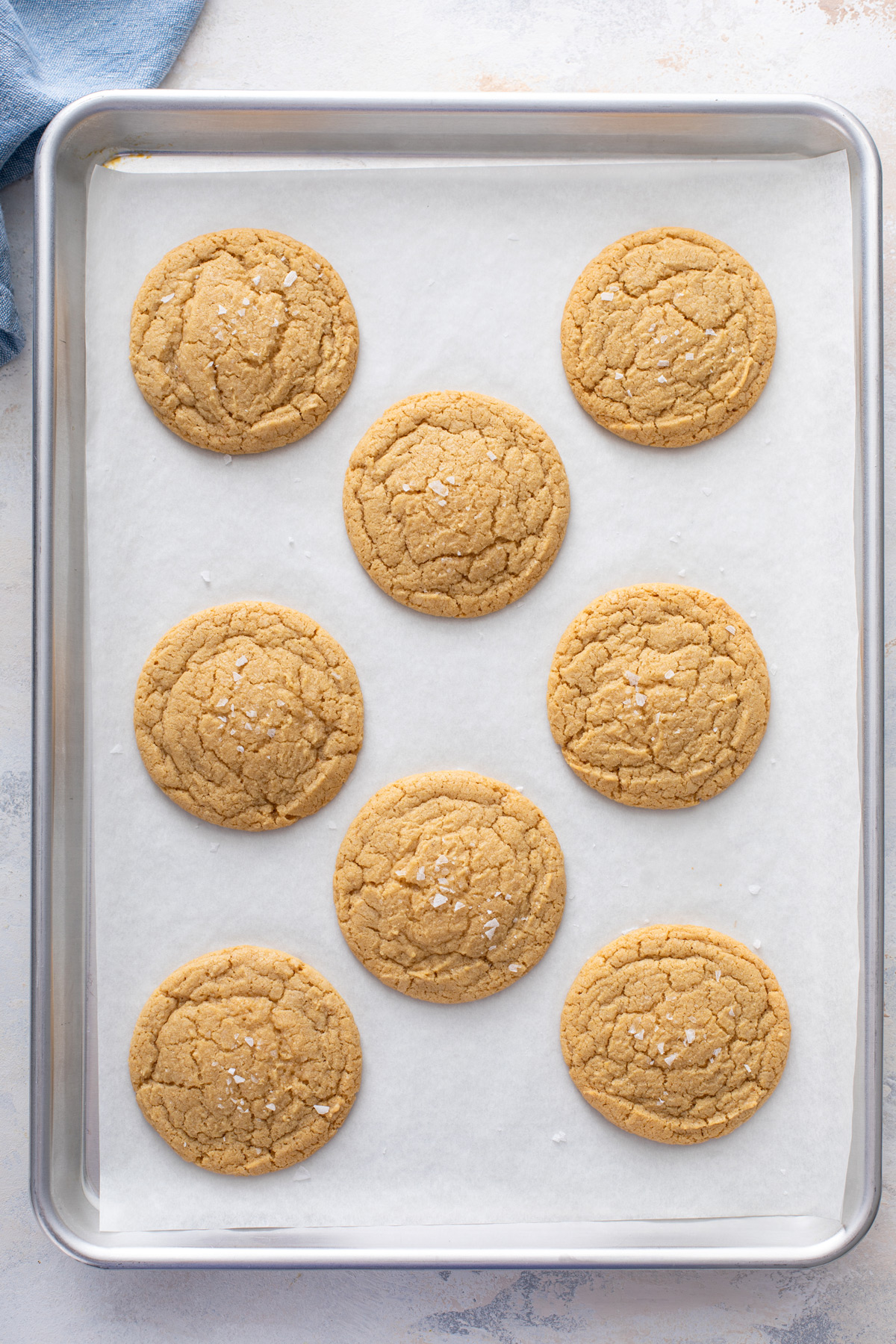 Baked chocolate chipless cookies cooling on a sheet pan.