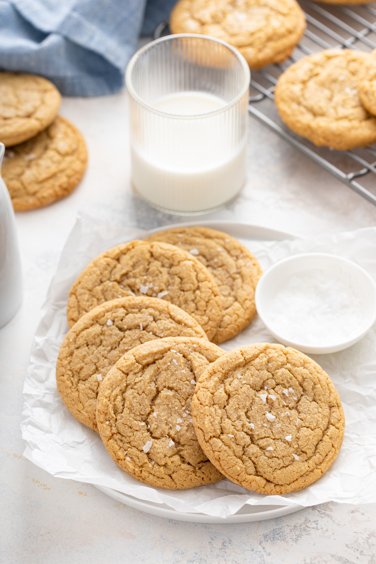 Several chocolate chipless cookies arranged on a plate lined with a piece of parchment paper.