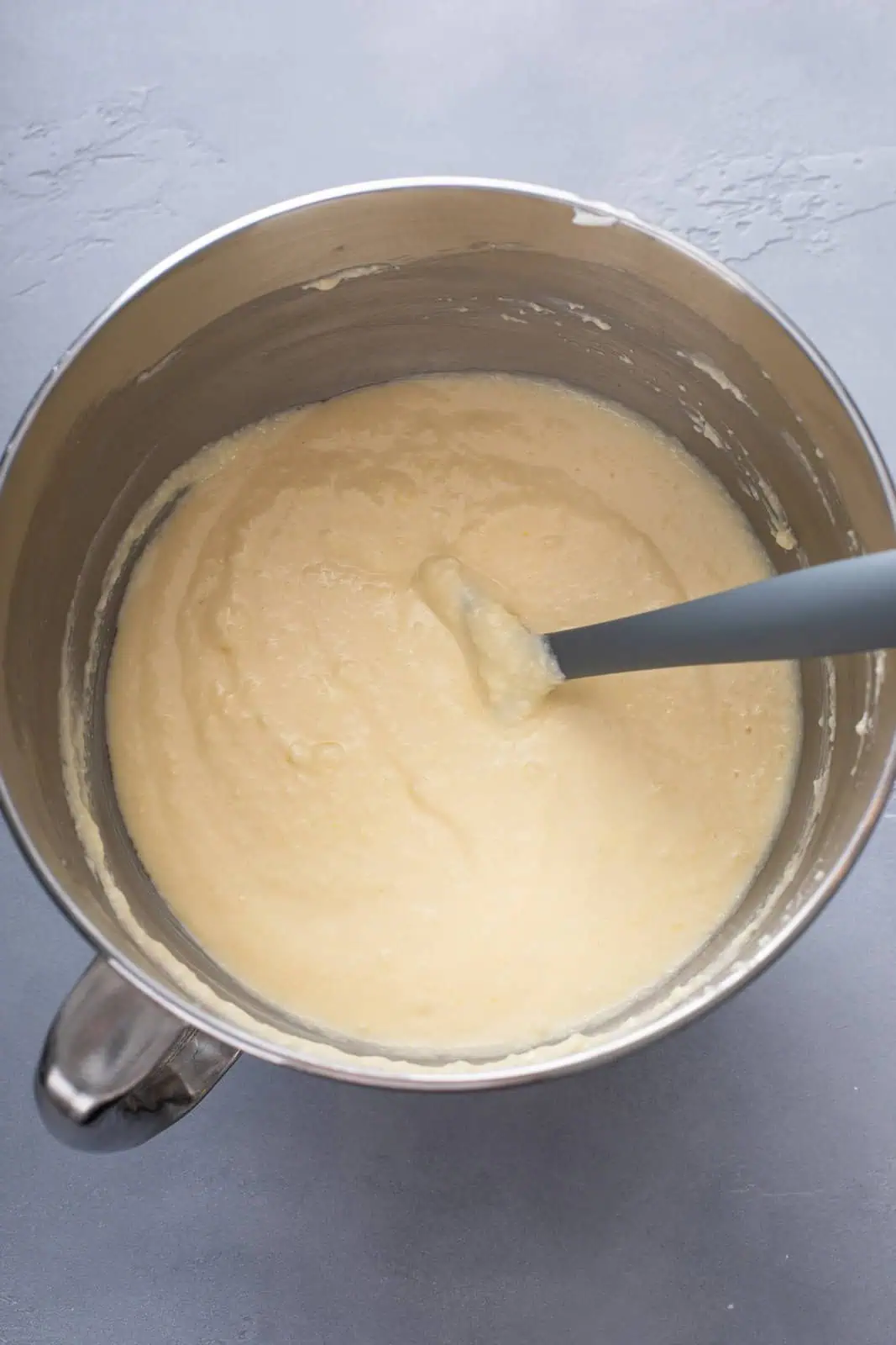 Wet ingredients for sour cream coffee cake mixed together in a metal bowl.