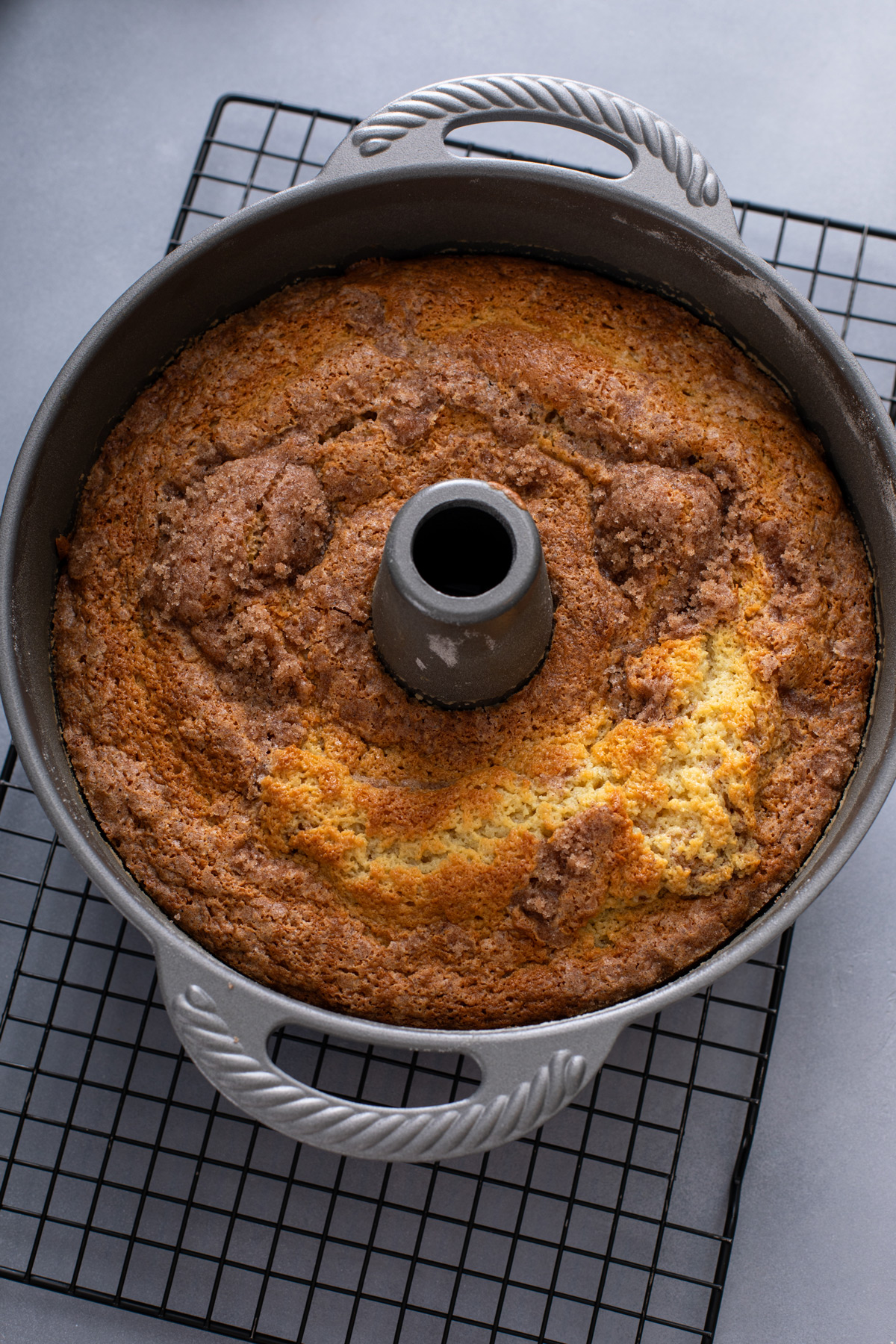 Baked sour cream coffee cake cooling on a wire rack.