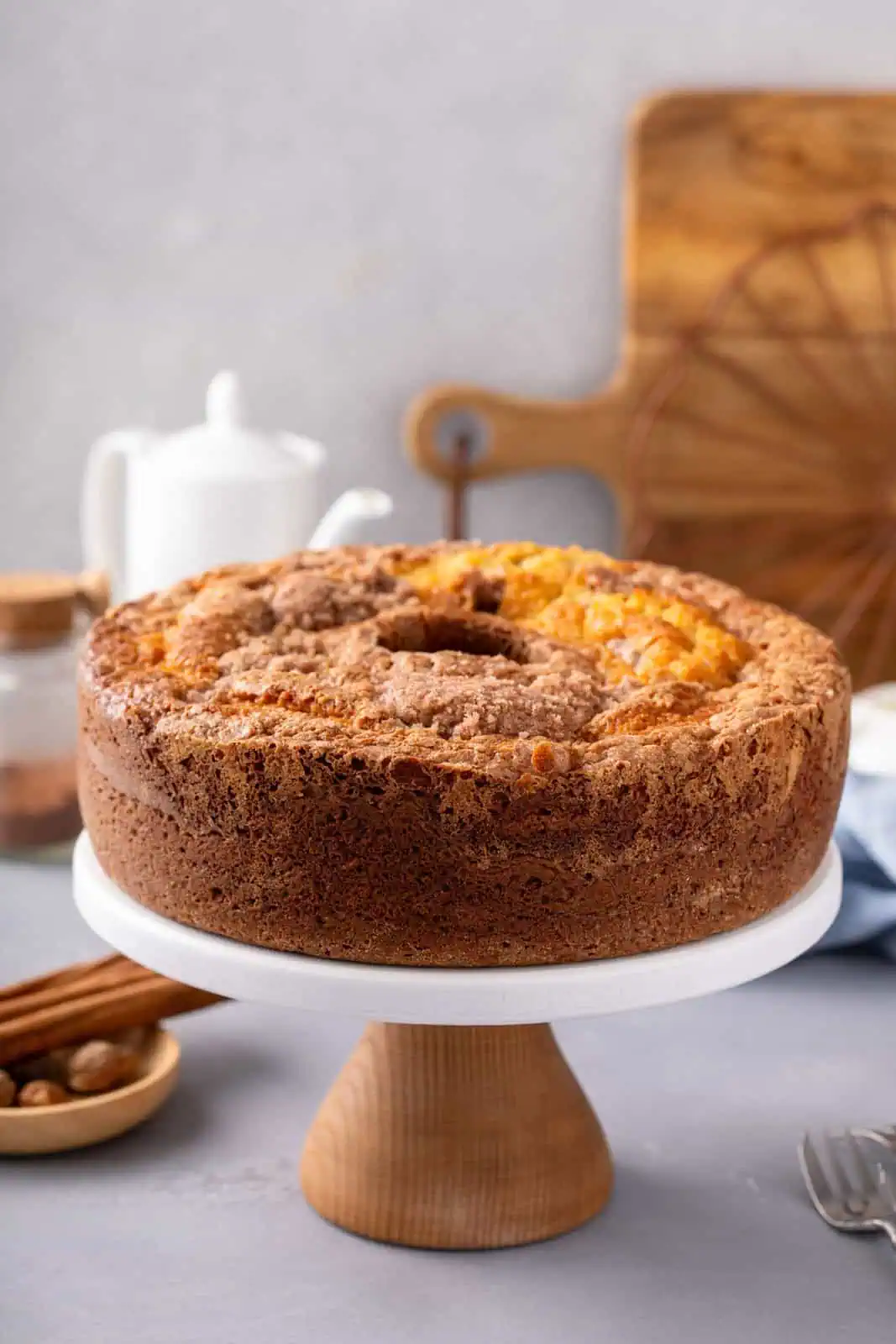 Cooled sour cream coffee cake set on a cake plate.