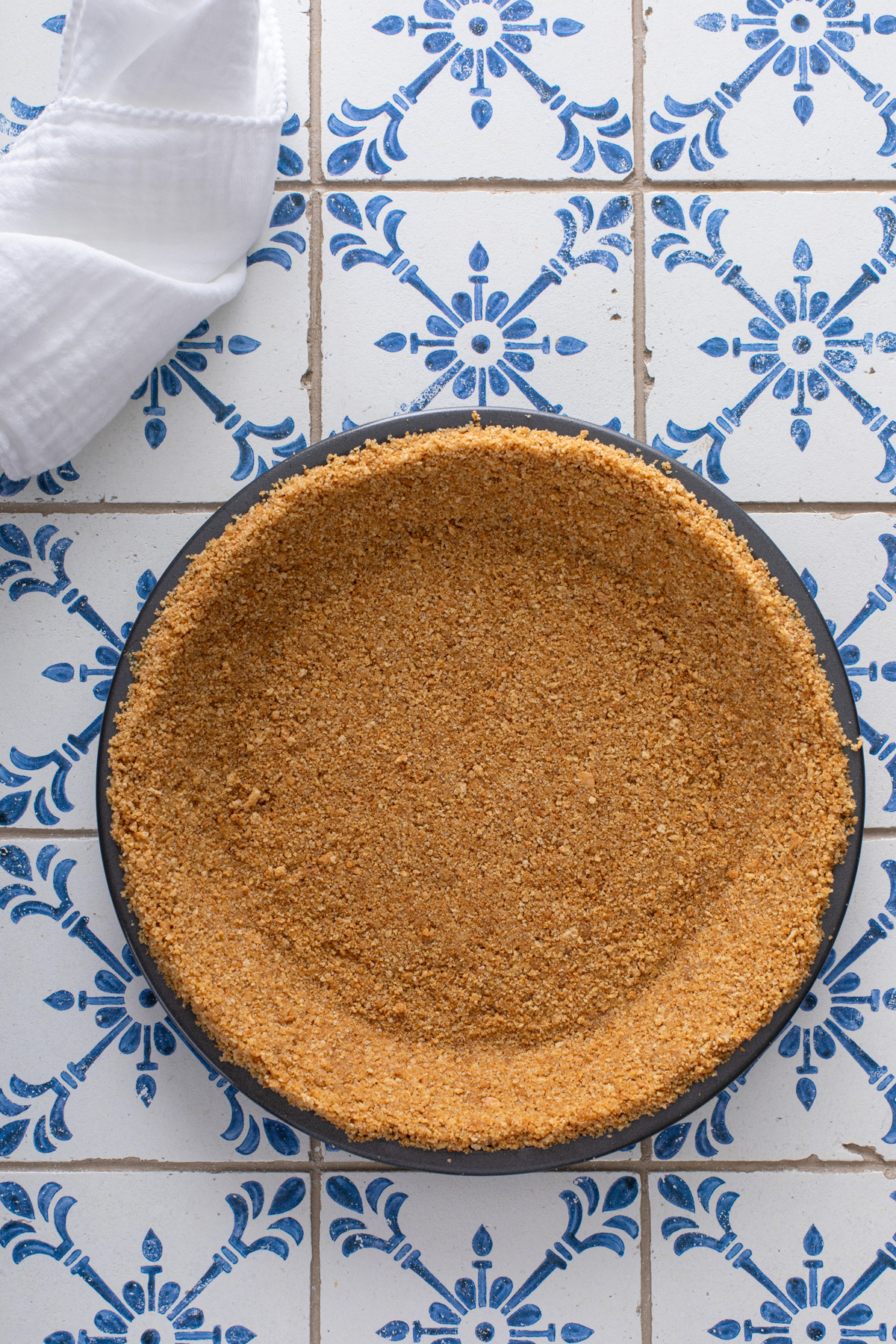 Graham cracker crust in a pie plate.