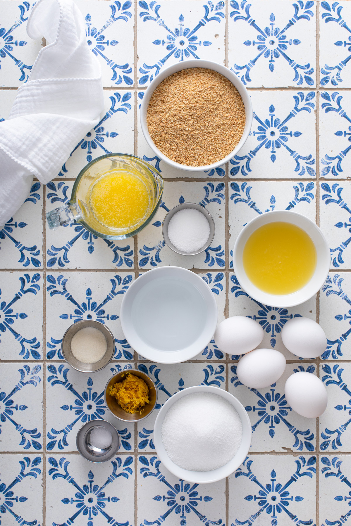 Lemon chiffon pie ingredients arranged on a blue and white countertop.