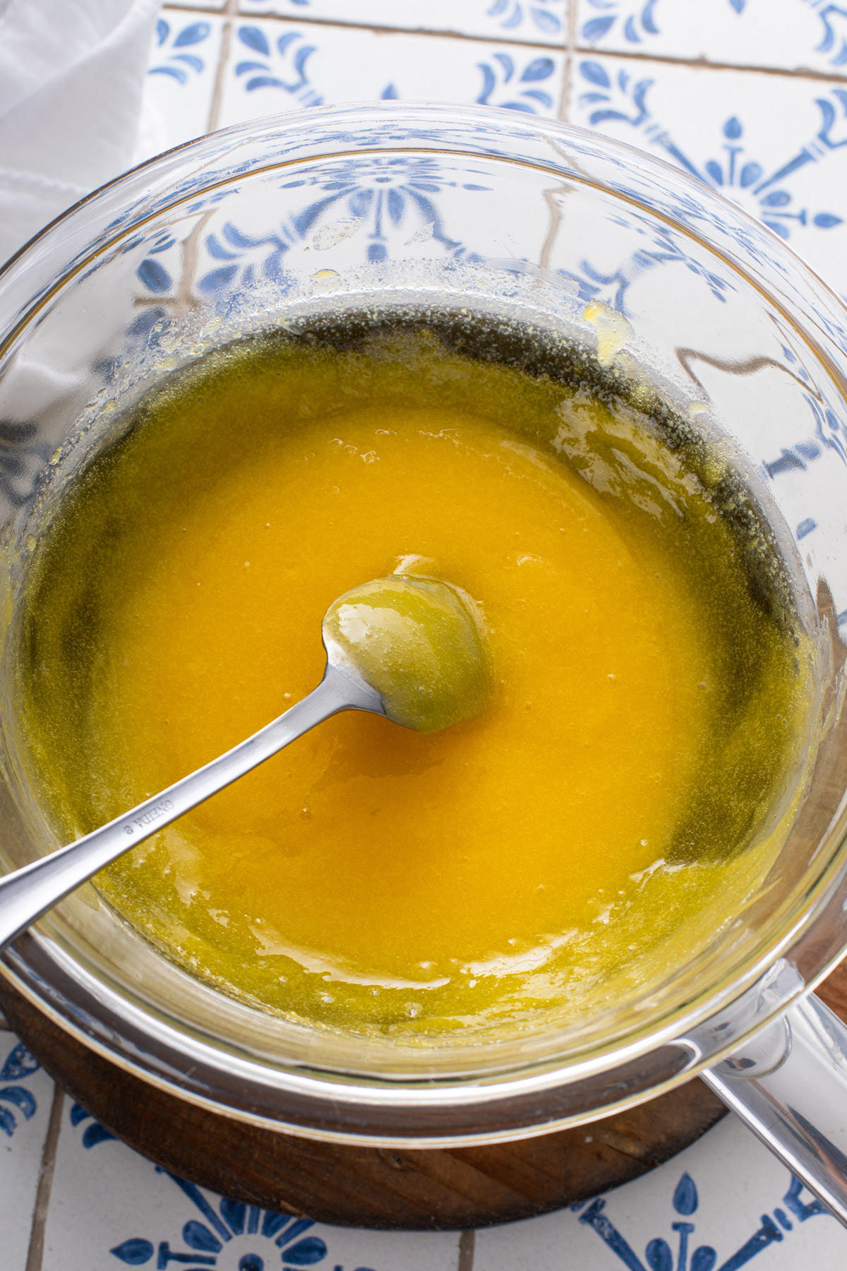 Lemon curd cooked in a glass bowl.